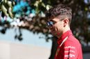 Charles Leclerc walks in the Paddock