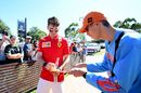 Charles Leclerc arrives at the circuit and signs autographs for fans