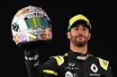 Daniel Ricciardo poses for a photo in the Paddock