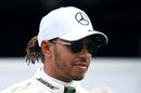 Lewis Hamilton looks on in the Paddock