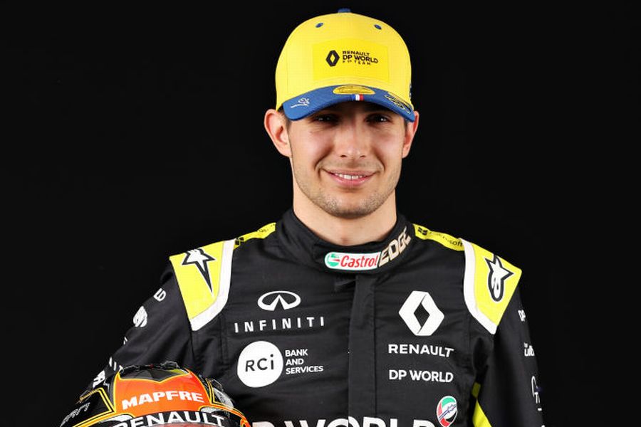 Esteban Ocon poses for a photo in the Paddock