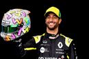Daniel Ricciardo poses for a photo in the Paddock