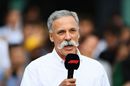 Chase Carey talks as a press conference is held outside the paddock