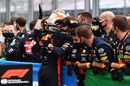Max Verstappen celebrates with team members in parc ferme
