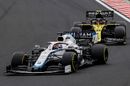 George Russell battles for position with Esteban Ocon on track