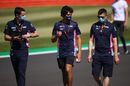 Lance Stroll walks on track with team members