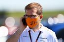 McLaren Team Principal Andreas Seidl talks on the phone in the Paddock