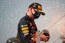 Race winner Max Verstappen celebrates on the podium with champagne