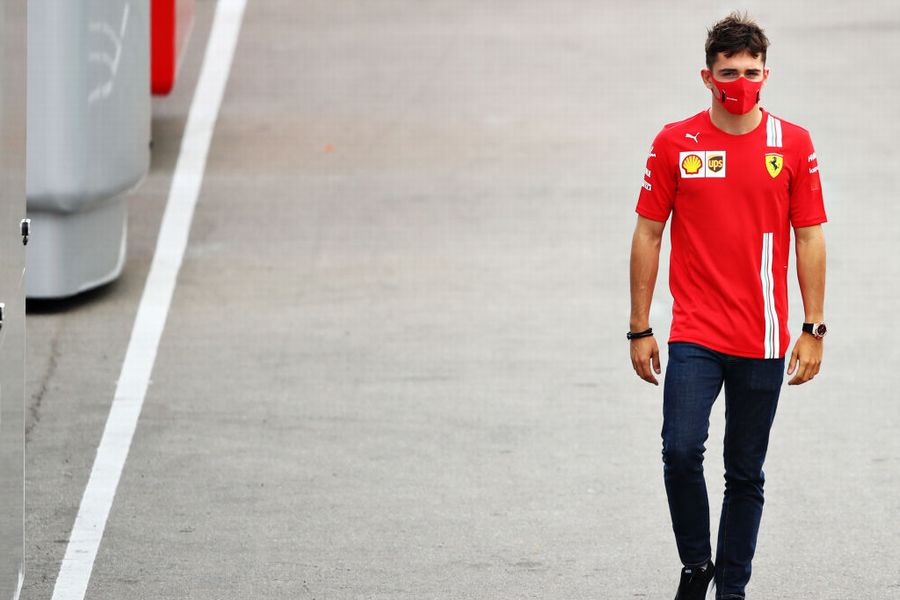 Charles Leclerc walks in the Paddock