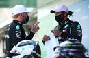 Pole sitter Lewis Hamilton talks with Valtteri Bottas in parc ferme