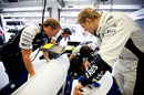 Nico Hulkenberg inspects his Williams with personal trainer Nick Harris