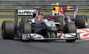 Michael Schumacher keeps an eye on his mirrors as Mark Webber closes in
