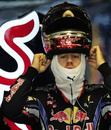 Sebastian Vettel dons his helmet 