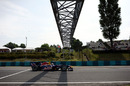 Sebastian Vettel flashes under the bridge