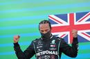 Race winner Lewis Hamilton celebrates on the podium