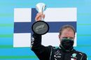 Valtteri Bottas celebrates on the podium with the trophy