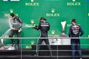 Top 3 drivers celebrate on the podium with champagne