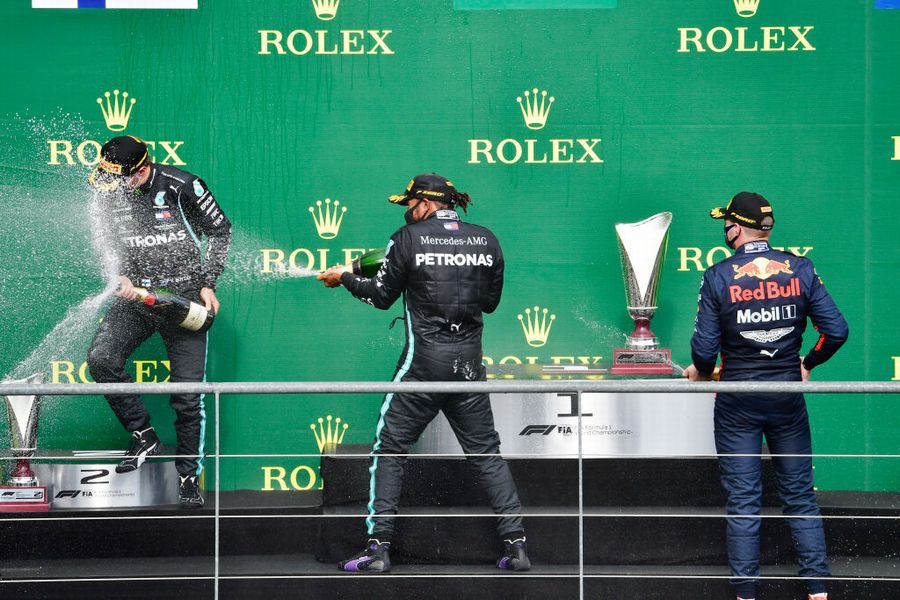 Top 3 drivers celebrate on the podium with champagne