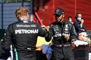 Pole sitter Lewis Hamilton celebrates with Valtteri Bottas in parc ferme