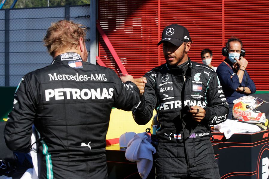 Pole sitter Lewis Hamilton celebrates with Valtteri Bottas in parc ferme