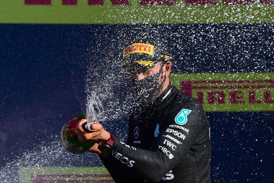 Race winner Lewis Hamilton celebrate on the podium with champagne