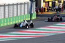 George Russell and Sebastian Vettel leaves the pit lane