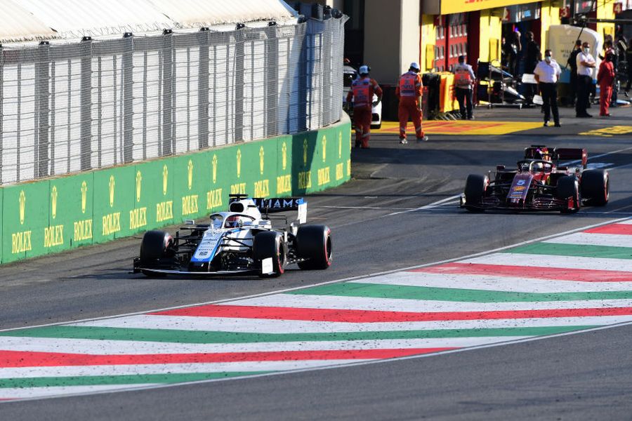 George Russell and Sebastian Vettel leaves the pit lane
