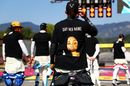 Lewis Hamilton wears a t-shirt displaying the message 'say her name' above a photo of Breonna Taylor