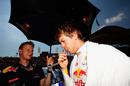 Sebastian Vettel takes on board liquid on the grid