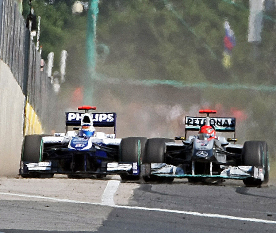 Michael Schumacher leaves Rubens Barrichello very little space as he tries to pass