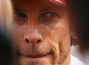 Jenson Button talks to the press after a difficult session