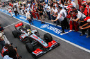 Lewis Hamilton celebrates victory on his return to the pits