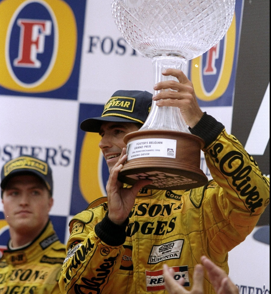 Damon Hill celebrates winning the Belgian Grand Prix as Ralf Schumacher looks on