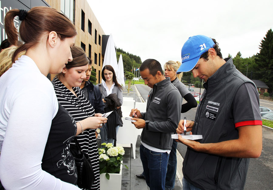 Bruno Senna and Sakon Yamamoto sign autographs outside their hotel