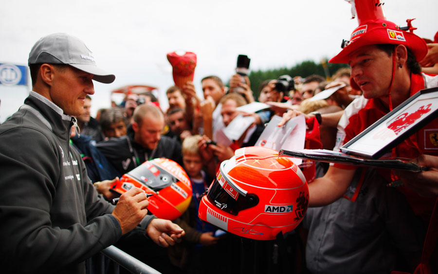 Michael Schumacher signs replica helmets