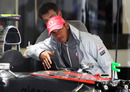 Lewis Hamilton poses with his car