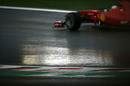Fernando Alonso negotiates a slippery circuit