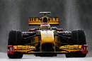 Water flicks up from Vitaly Petrov's full wet tyres