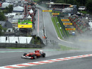 Fernando Alonso powers through Eau Rouge in the wet