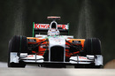 Adrian Sutil's tyres throw up an arc of water
