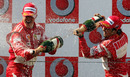 Ferrari's Michael Schumacher and Felipe Massa celebrate on the podium