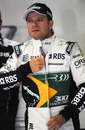 Rubens Barrichello zips up his new race suit for action