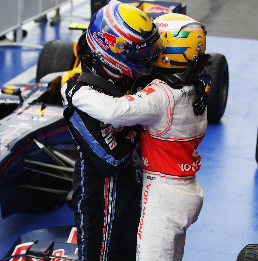 Lewis Hamilton receives a victory hug from Mark Webber