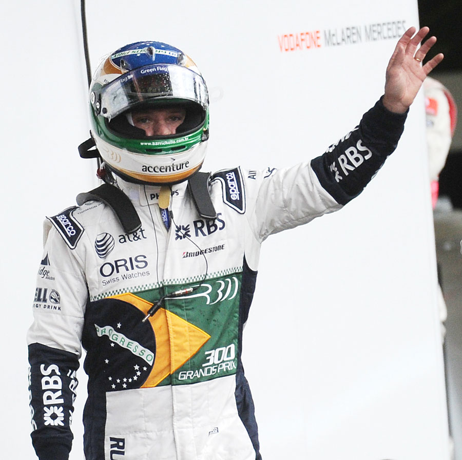 Rubens Barrichello waves to his fans after crashing out