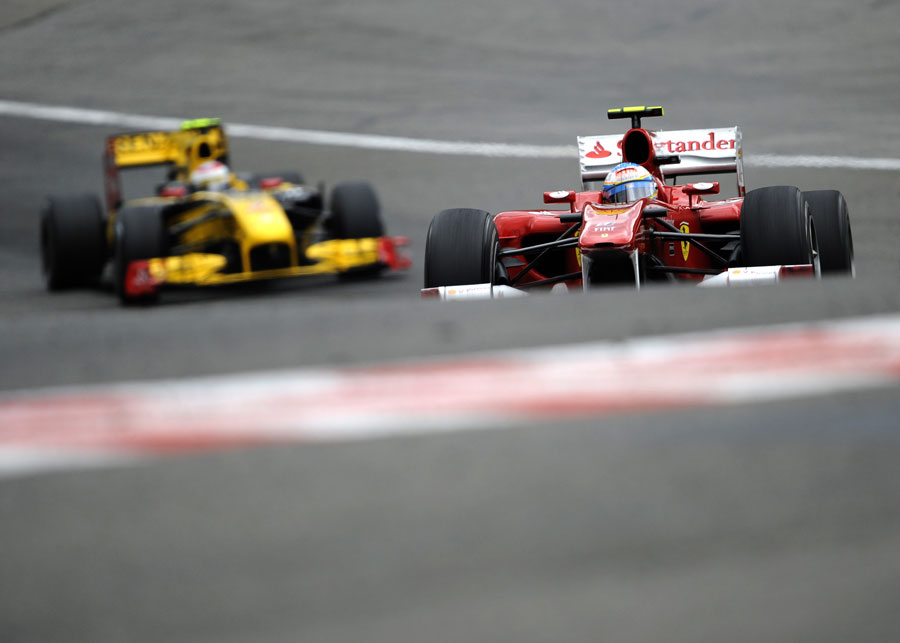 Fernando Alonso leads Vitaly Petrov