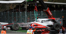 Jenson Button's wrecked McLaren is cleared away