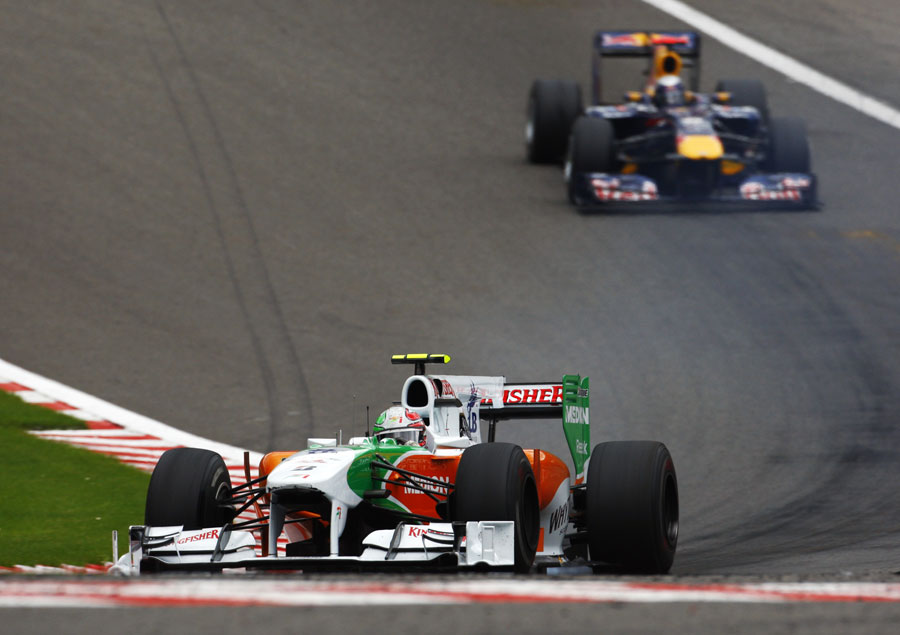 Tonio Liuzzi leads Sebastian Vettel through Eau Rouge