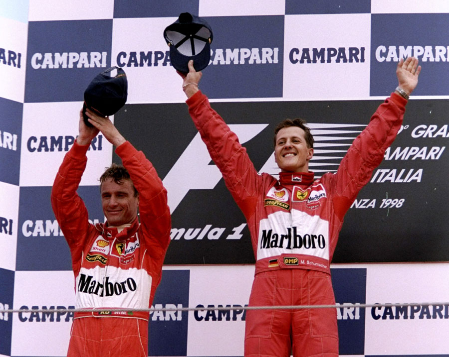 Michael Schumacher celebrates a Ferrari 1-2 with team-mate Eddie Irvine