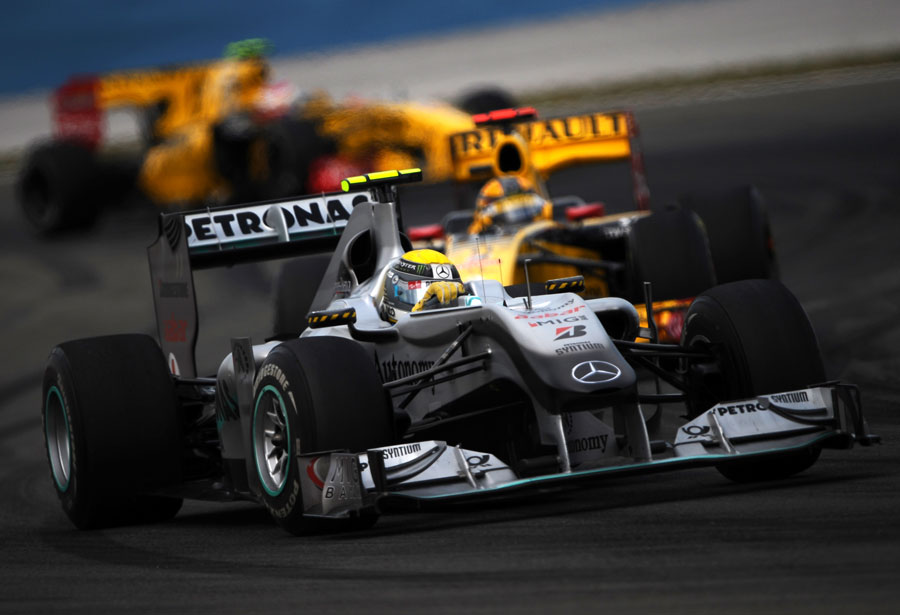 Robert Kubcia and Vitaly Petrov hunt down Nico Rosberg