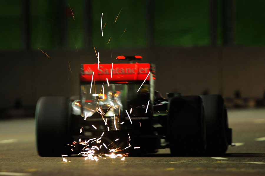 Sparks fly from the back of Lewis Hamilton's McLaren
